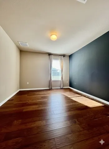 a spacious bathroom with a double vanity sink and a mirror