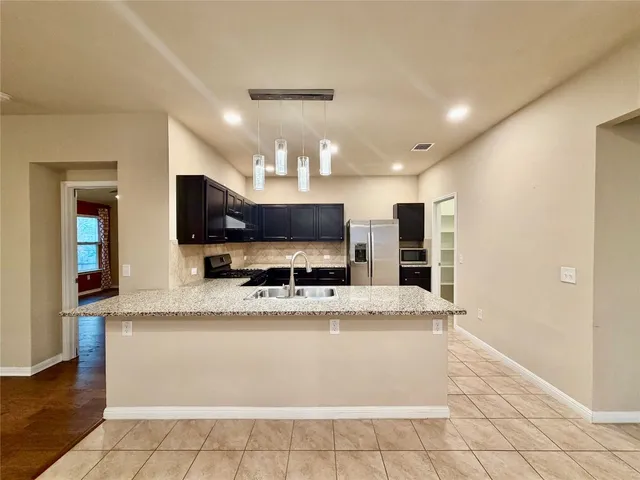 a view of kitchen with cabinets and wooden floor