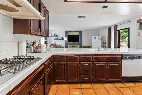 a kitchen with stainless steel appliances a stove and a sink