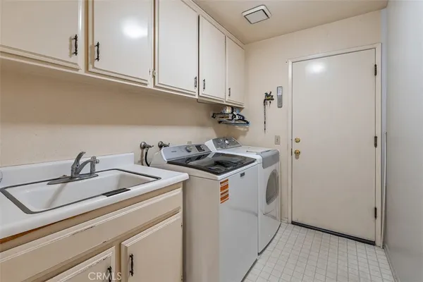 a kitchen with a sink a stove and cabinets