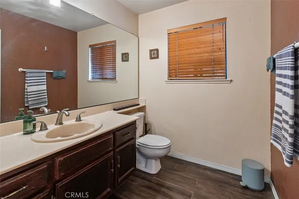 a bathroom with a sink a toilet and mirror