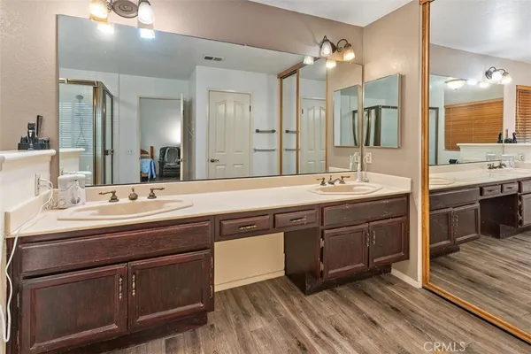 a bathroom with a sink double vanity and a mirror