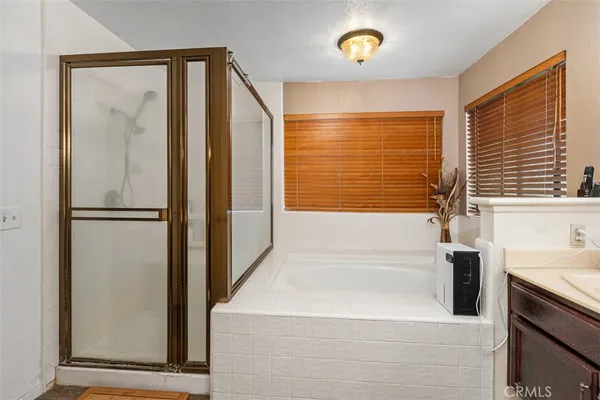 a bathroom with a bathtub and a shower