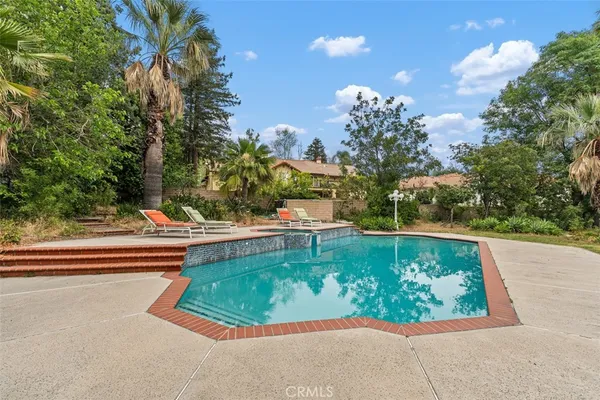 a view of a swimming pool with a yard