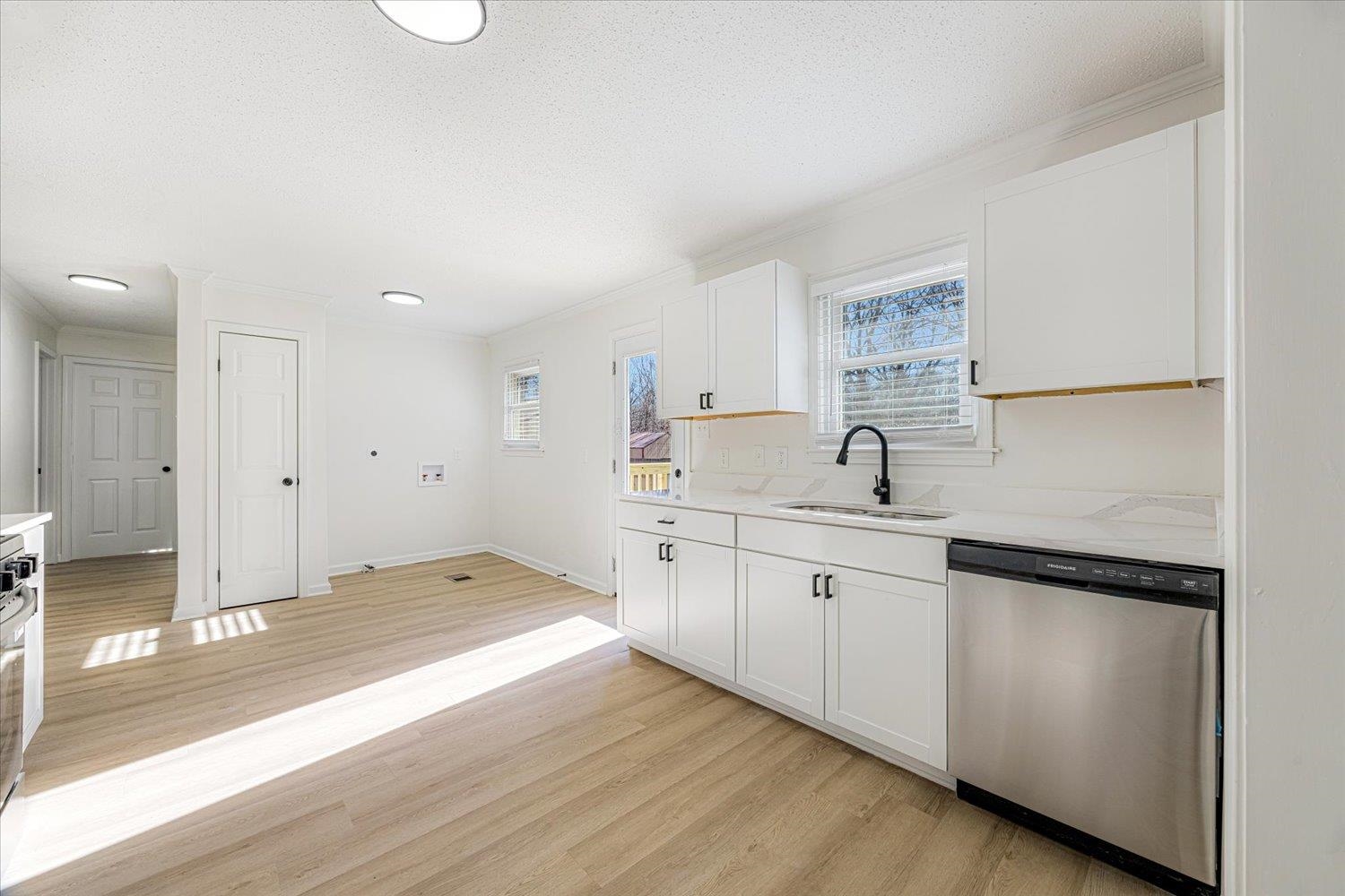3148 Beaver Road Munford, TN 38058 - Photo 11 of 26 a kitchen with granite countertop white cabinets and white appliances