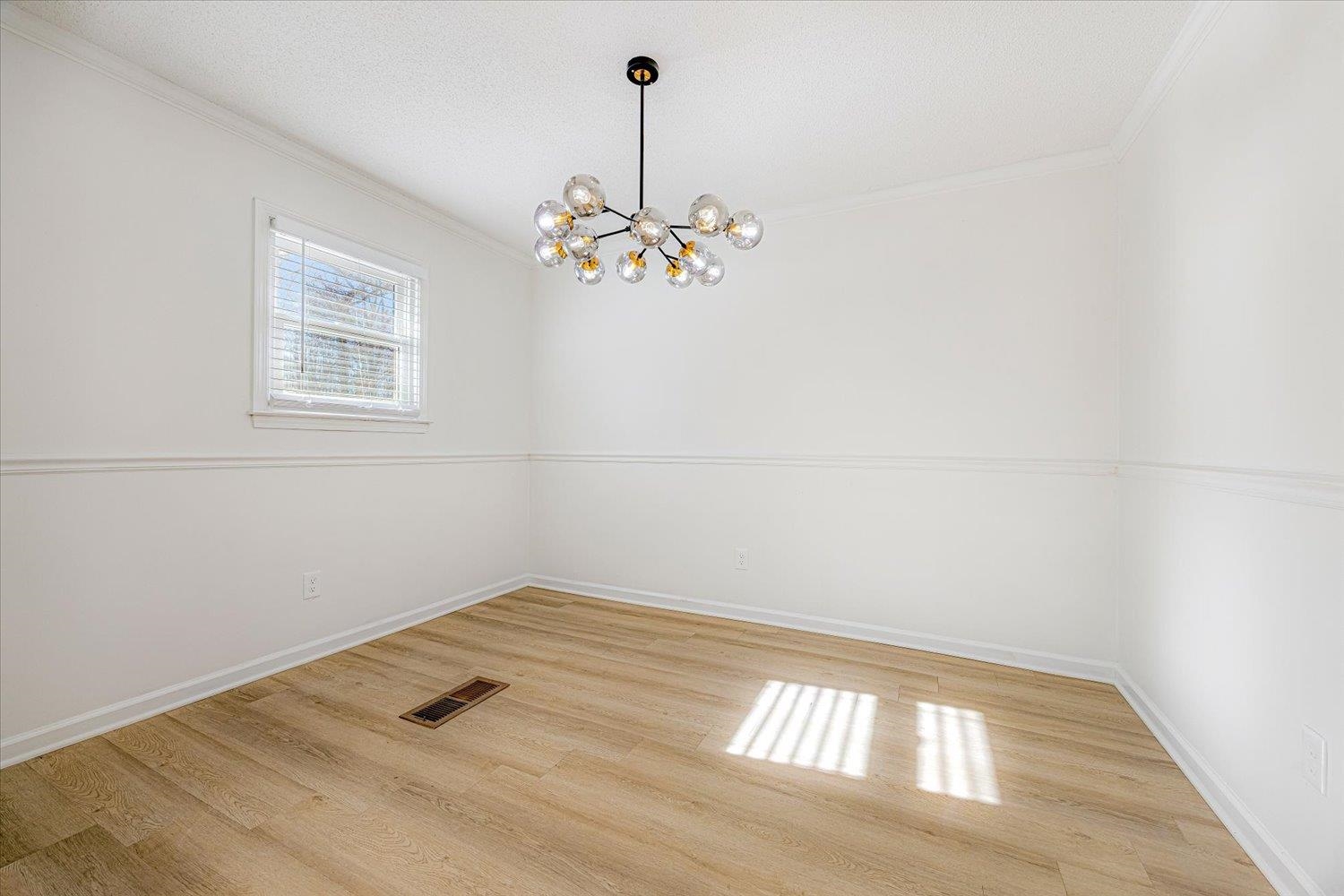 3148 Beaver Road Munford, TN 38058 - Photo 12 of 26 a view of a room with wooden floor and chandelier