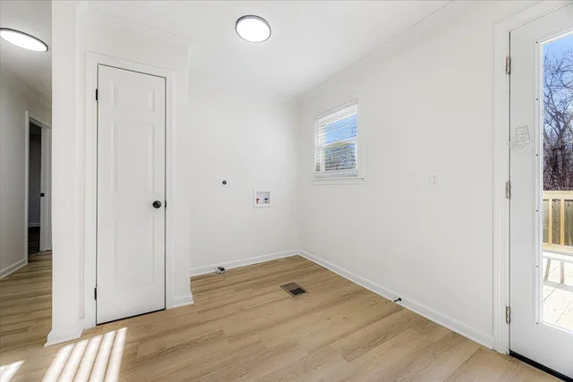 a view of a room with wooden floor and a window