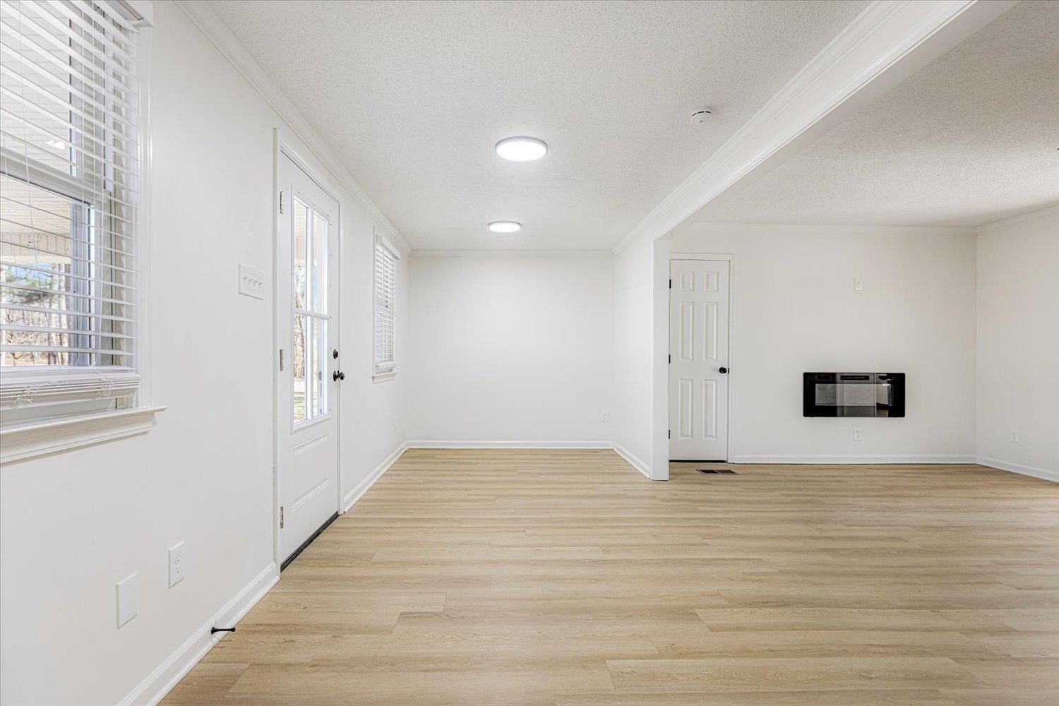 3148 Beaver Road Munford, TN 38058 - Photo 5 of 26 a view of an empty room with wooden floor and a window