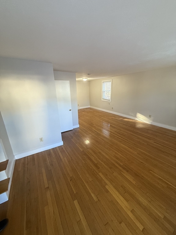 39 Silvia Court, Unit 39 Boston, MA 02136 - Photo 11 of 20 a view of empty room with wooden floor