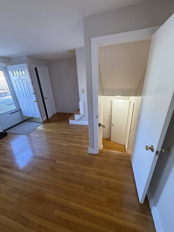 39 Silvia Court, Unit 39 Boston, MA 02136 - Photo 14 of 20 a view of an empty room with wooden floor and a window