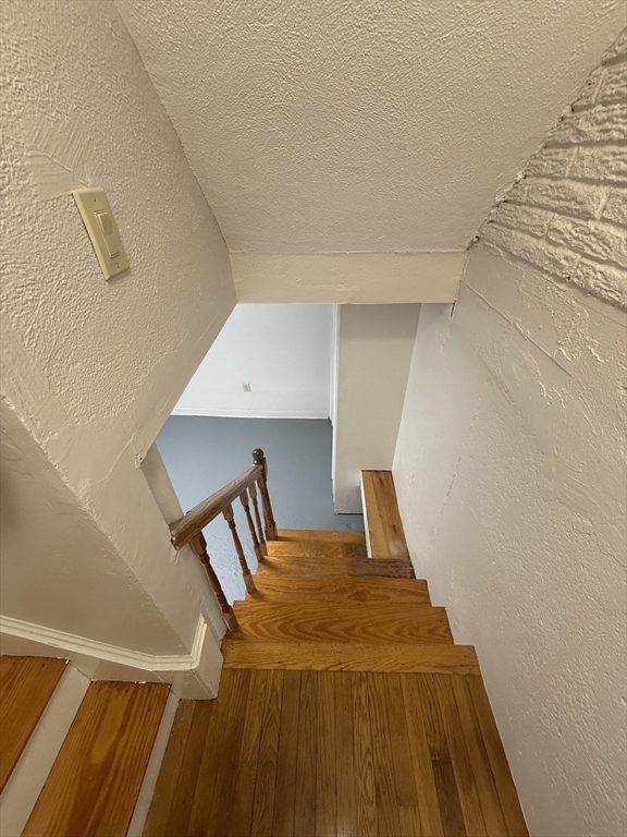 39 Silvia Court, Unit 39 Boston, MA 02136 - Photo 15 of 20 a bedroom with a bed and wooden floor