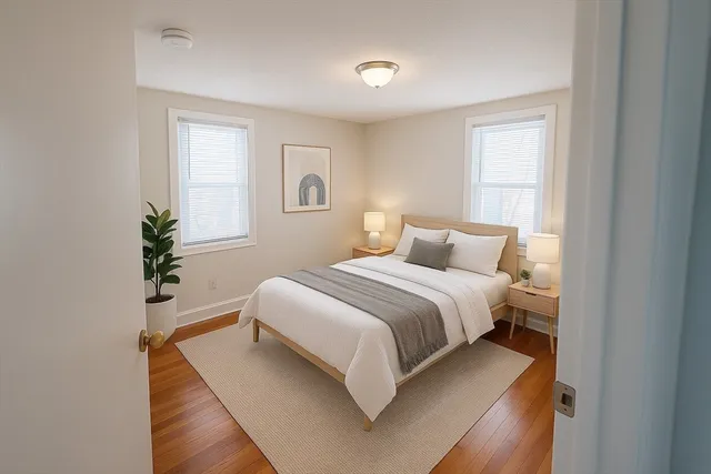 a bedroom with a bed and a potted plant