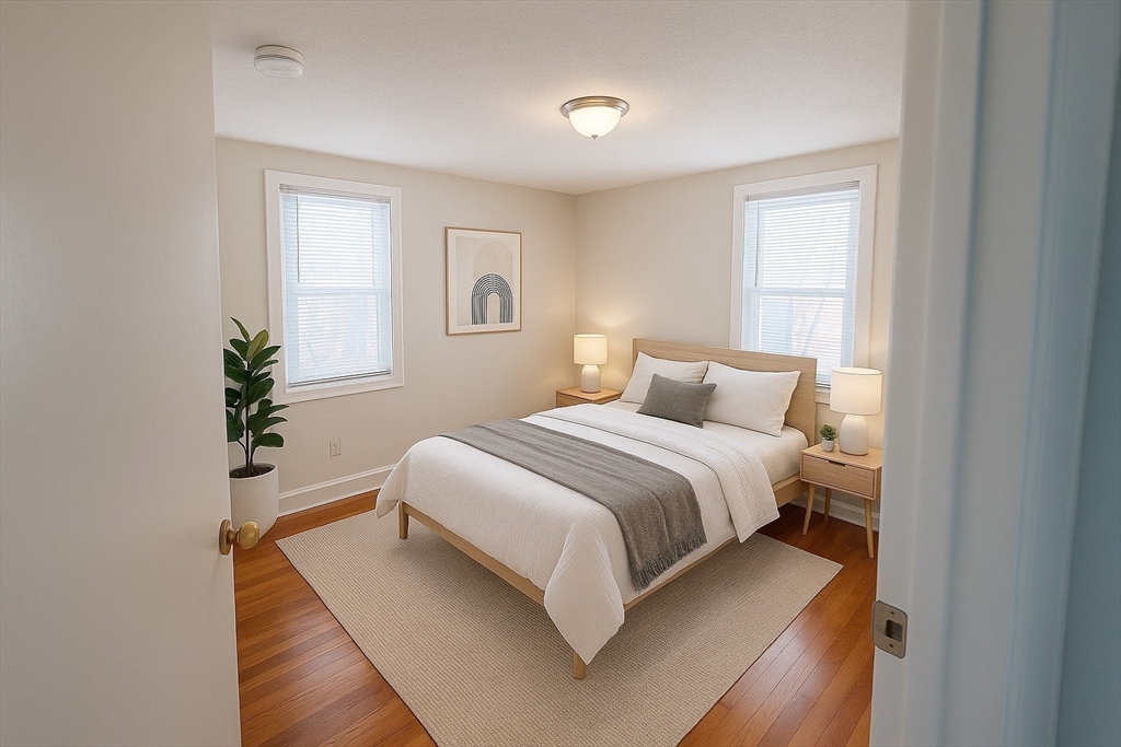 39 Silvia Court, Unit 39 Boston, MA 02136 - Photo 4 of 20 a bedroom with a bed and a potted plant