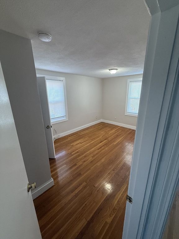39 Silvia Court, Unit 39 Boston, MA 02136 - Photo 6 of 20 wooden floor in an empty room with a mirror