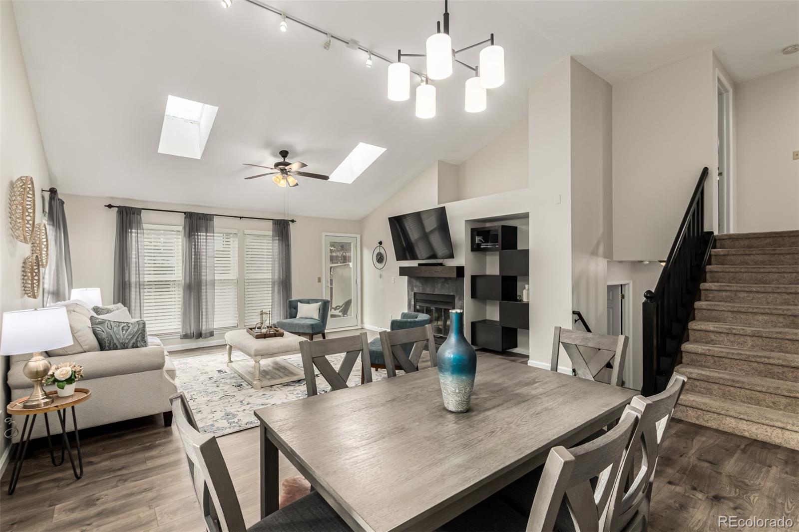 8837 South Cactus Flower Way Highlands Ranch, CO 80126 - Photo 11 of 42 a view of a dining room with furniture wooden floor and chandelier
