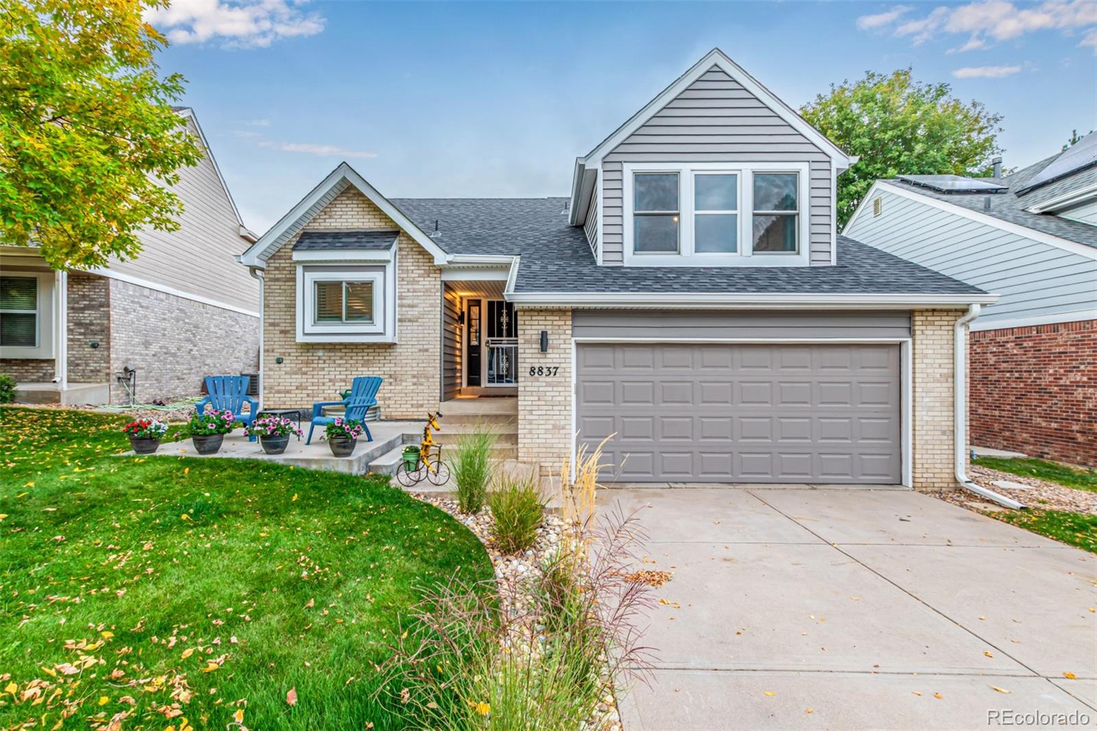 8837 South Cactus Flower Way Highlands Ranch, CO 80126 - Photo 2 of 42 a front view of a house with a yard and garage