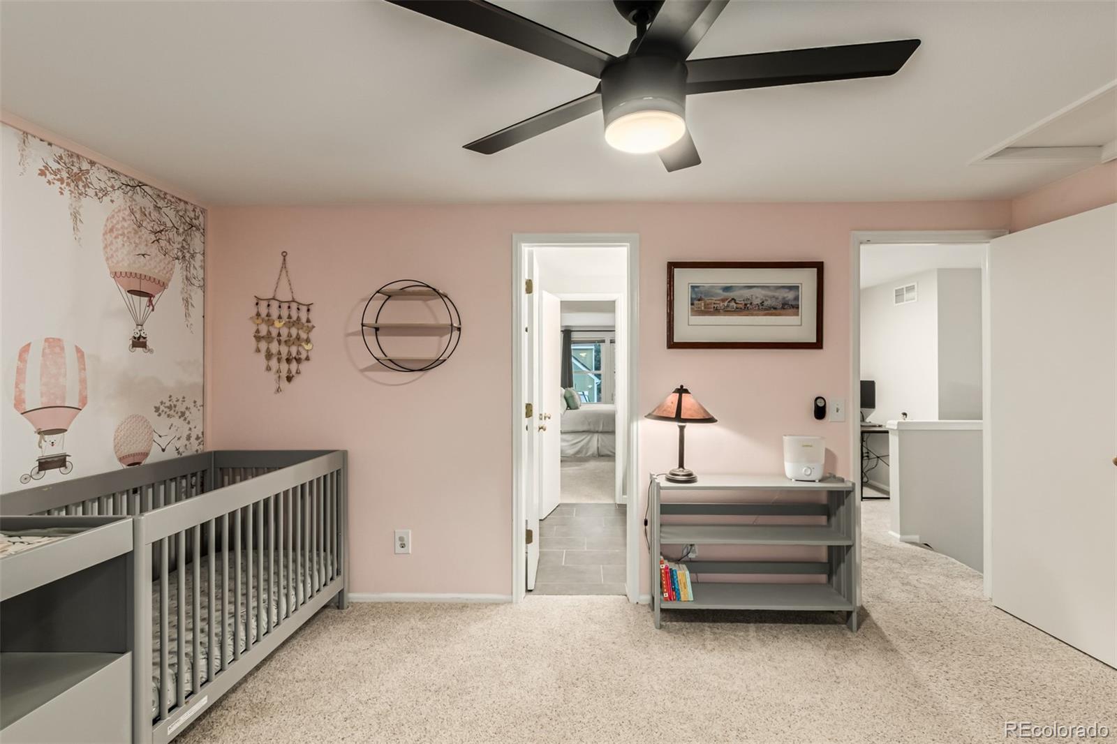 8837 South Cactus Flower Way Highlands Ranch, CO 80126 - Photo 28 of 42 a bedroom with furniture and a chandelier fan