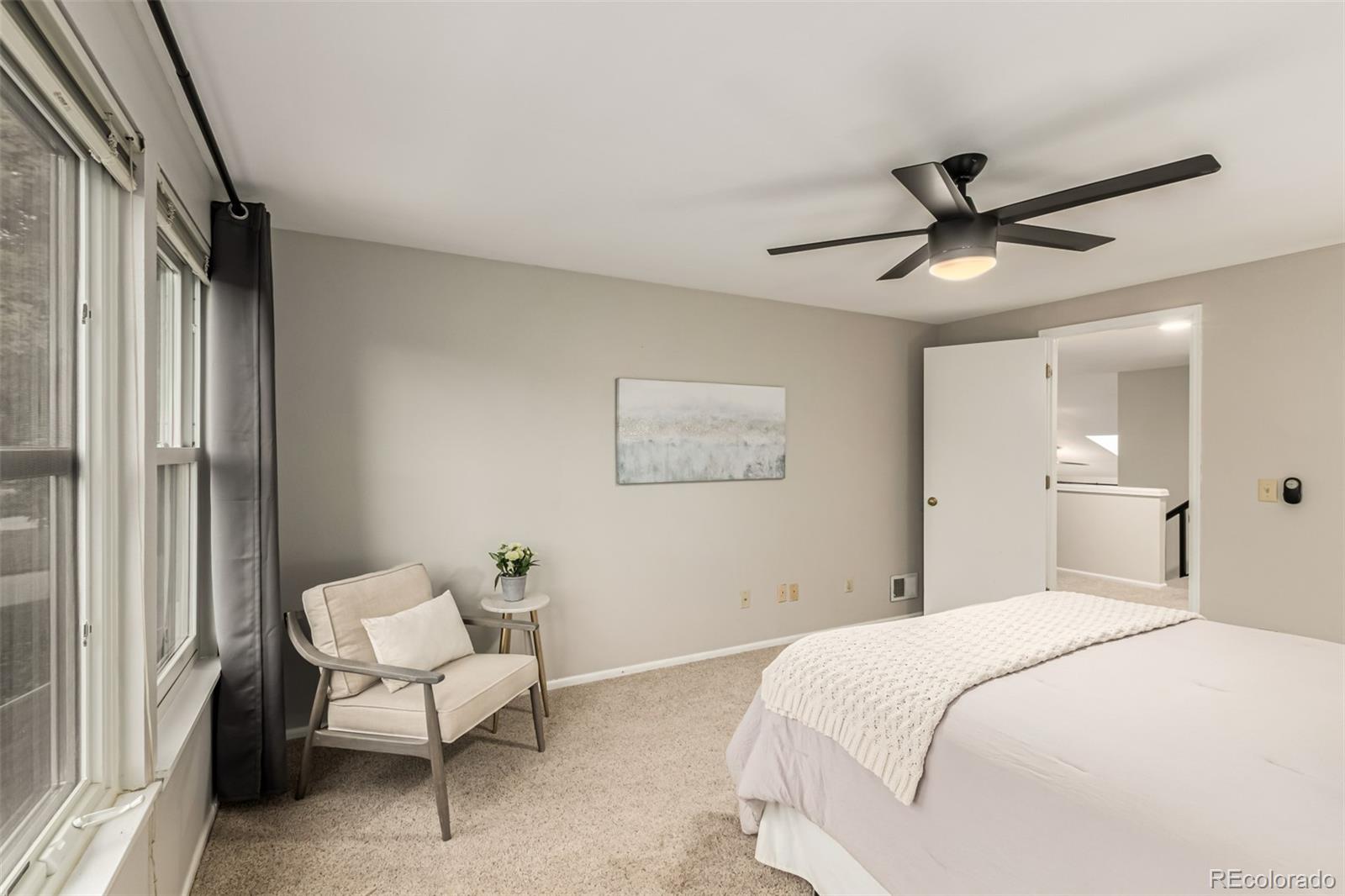 8837 South Cactus Flower Way Highlands Ranch, CO 80126 - Photo 30 of 42 a bedroom with a bed and a chandelier