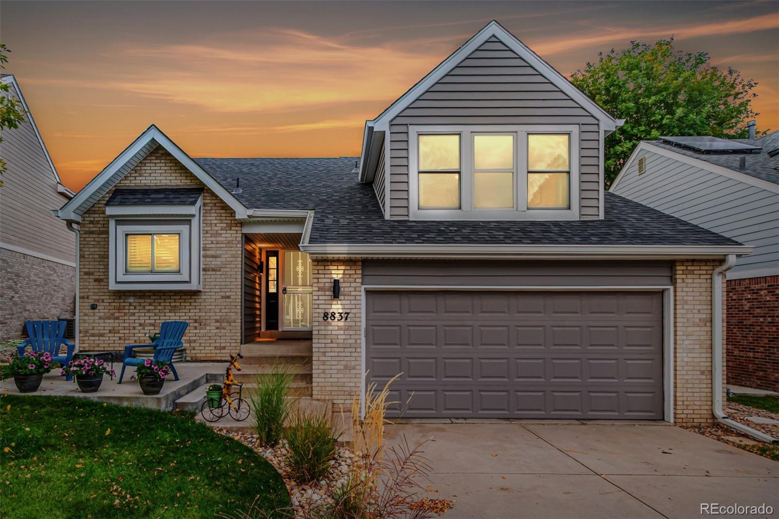 8837 South Cactus Flower Way Highlands Ranch, CO 80126 - Photo 3 of 42 a front view of a house with a garden