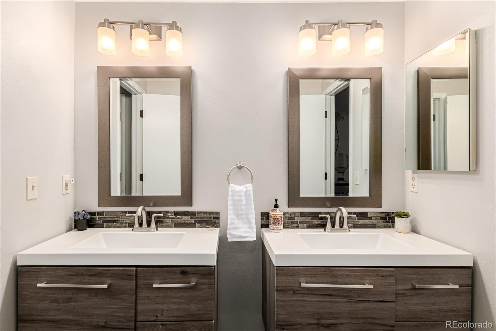 8837 South Cactus Flower Way Highlands Ranch, CO 80126 - Photo 31 of 42 a bathroom with double vanity sinks and a mirror