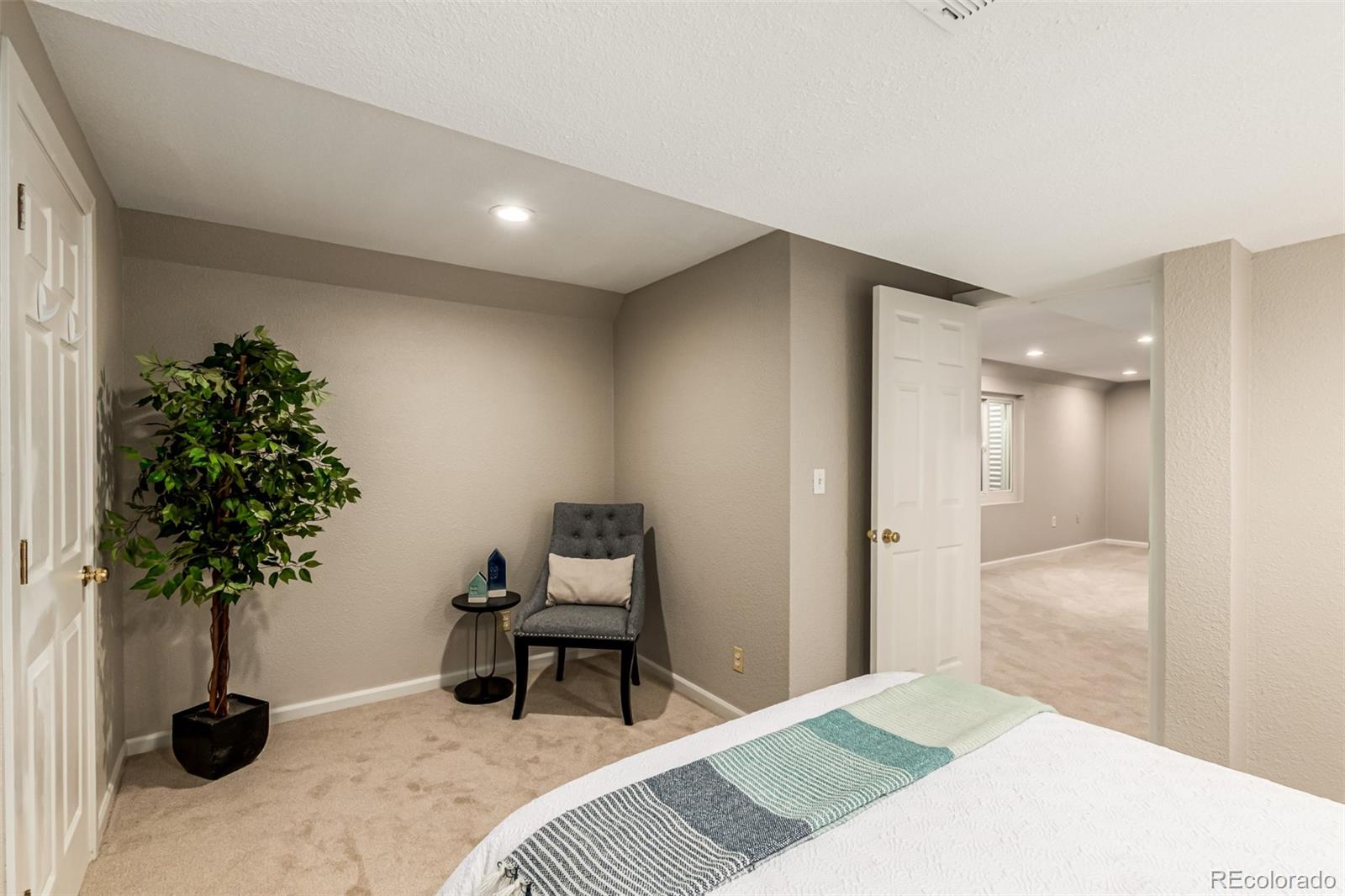 8837 South Cactus Flower Way Highlands Ranch, CO 80126 - Photo 36 of 42 a bedroom with a bed and a potted plant