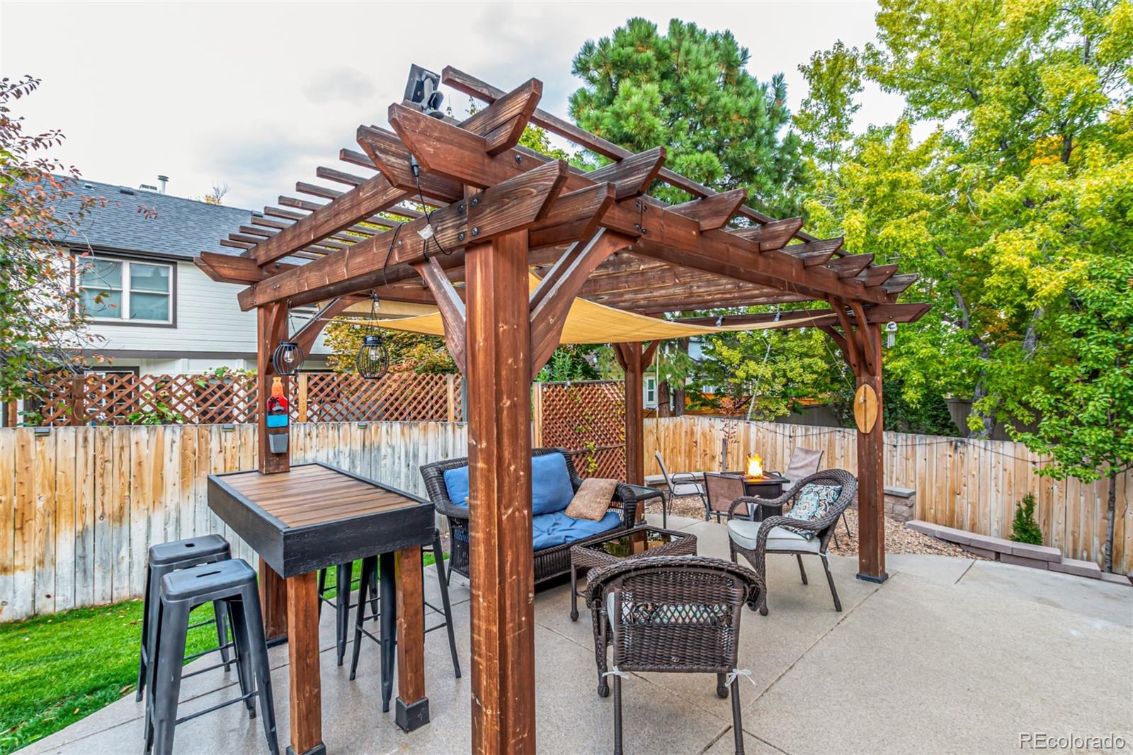 8837 South Cactus Flower Way Highlands Ranch, CO 80126 - Photo 40 of 42 a view of a patio with table and chairs potted plants and a palm tree