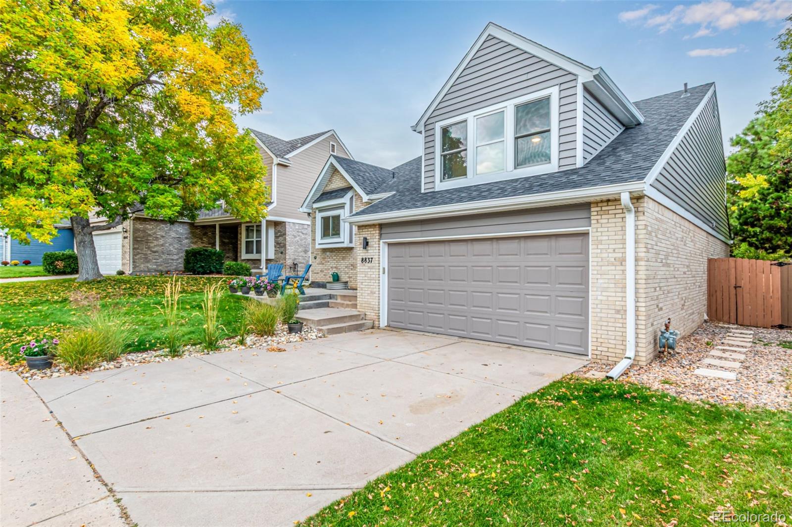 8837 South Cactus Flower Way Highlands Ranch, CO 80126 - Photo 4 of 42 a front view of a house with a garden