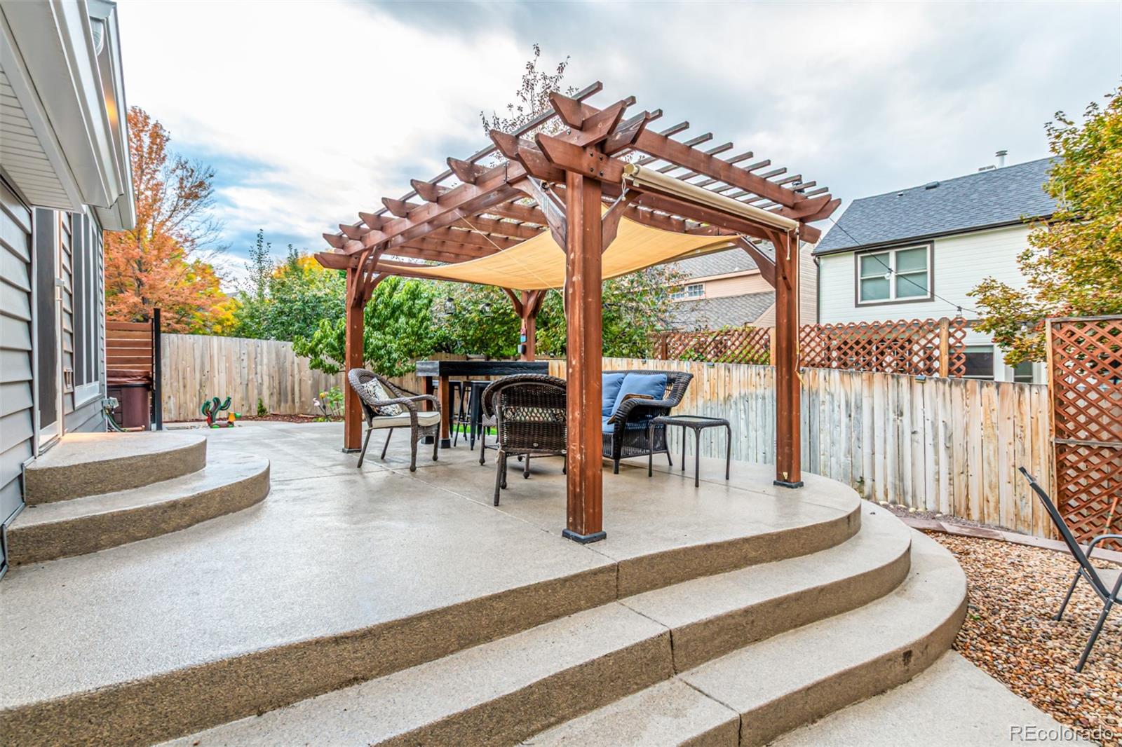 8837 South Cactus Flower Way Highlands Ranch, CO 80126 - Photo 41 of 42 a view of a patio with a table chairs and a floor to ceiling window