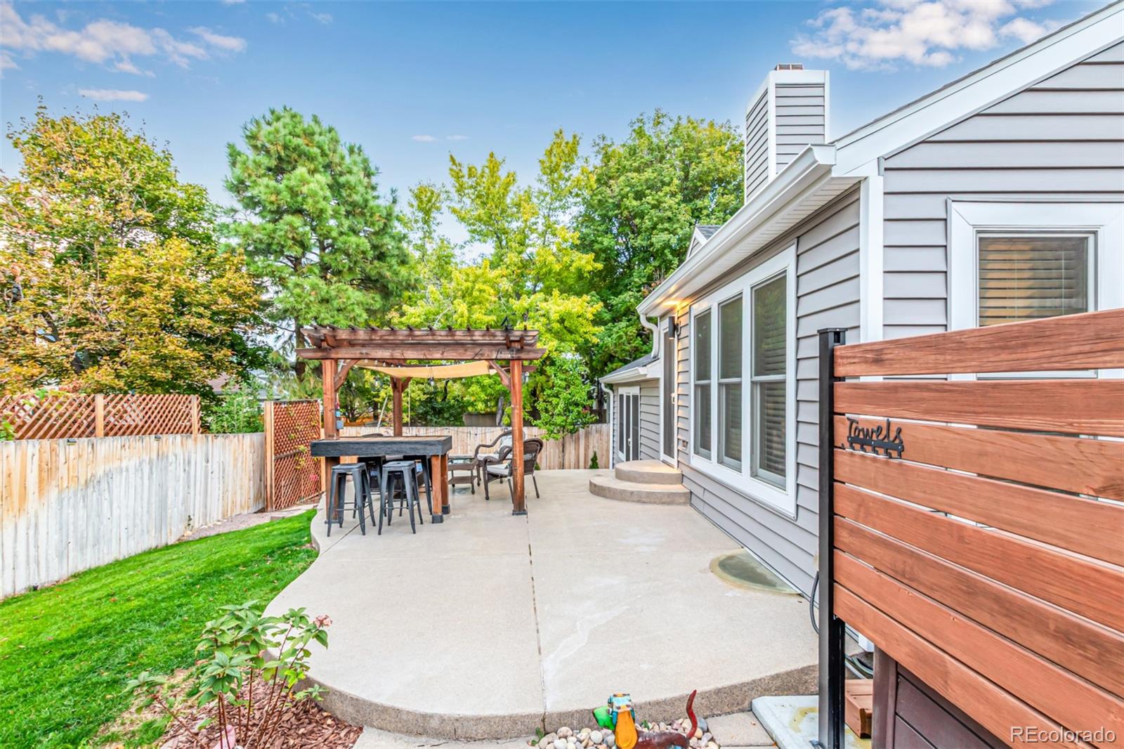 8837 South Cactus Flower Way Highlands Ranch, CO 80126 - Photo 6 of 42 a view of a patio with table and chairs potted plants and floor to ceiling window