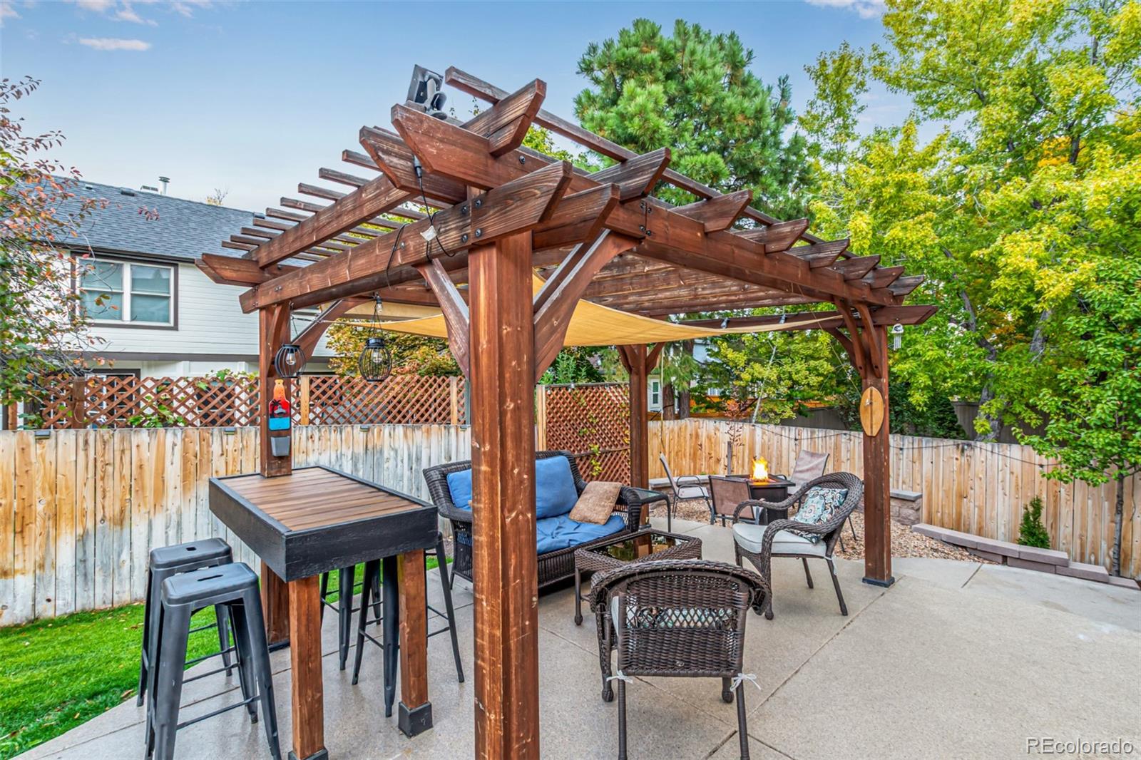 8837 South Cactus Flower Way Highlands Ranch, CO 80126 - Photo 8 of 42 a view of a patio with table and chairs potted plants and a palm tree