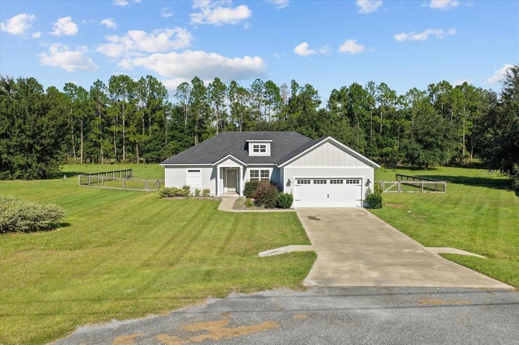 335 Southwest Arrowbend Drive Lake City, FL 32024 - Photo 1 of 50 a front view of a house with a yard