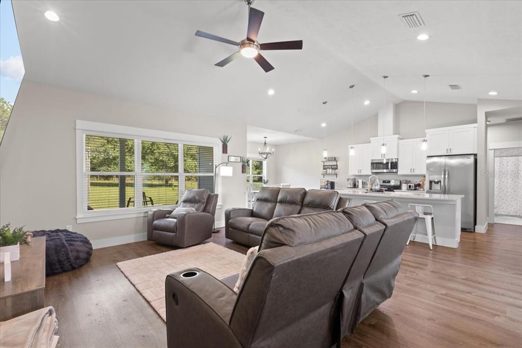 335 Southwest Arrowbend Drive Lake City, FL 32024 - Photo 12 of 50 a living room with furniture kitchen area and a large window