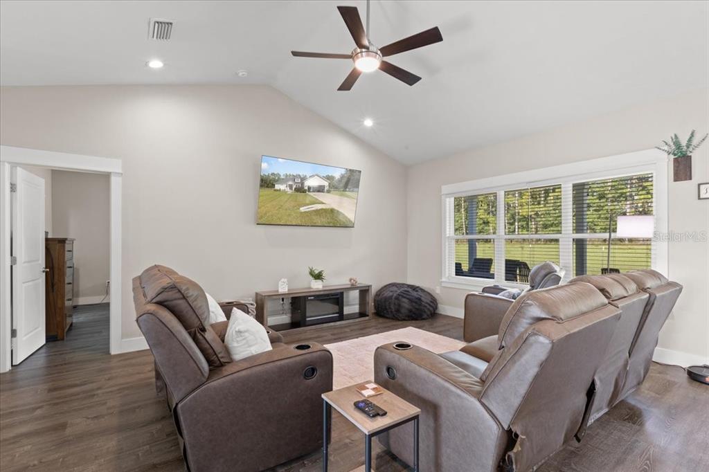 335 Southwest Arrowbend Drive Lake City, FL 32024 - Photo 14 of 50 a living room with furniture ceiling fan and a large window