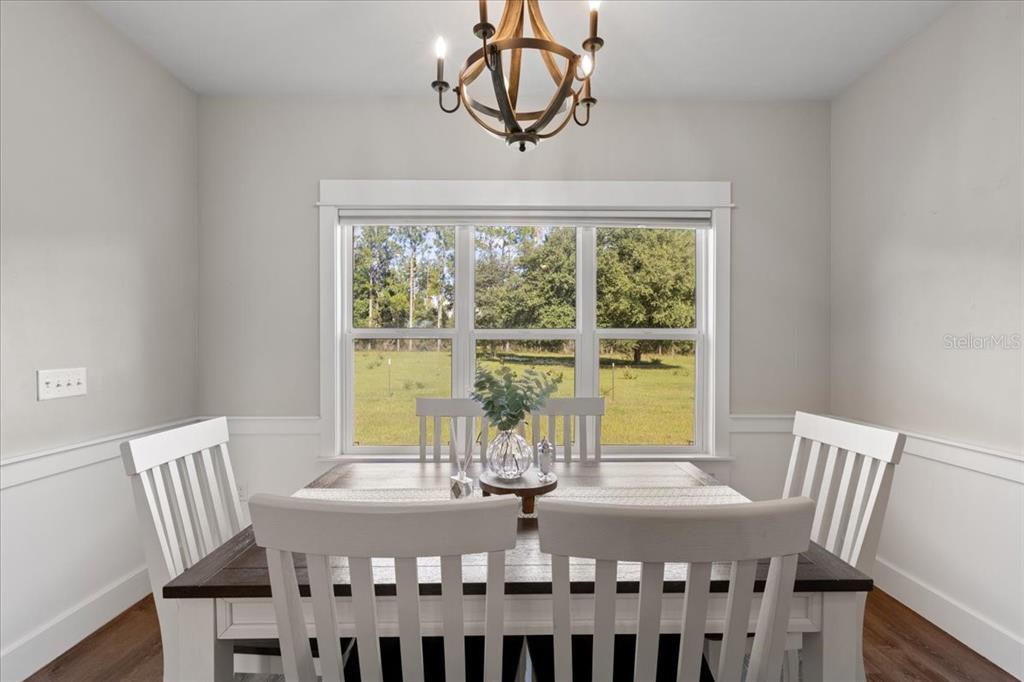 335 Southwest Arrowbend Drive Lake City, FL 32024 - Photo 16 of 50 a view of a dining room with furniture window and outside view