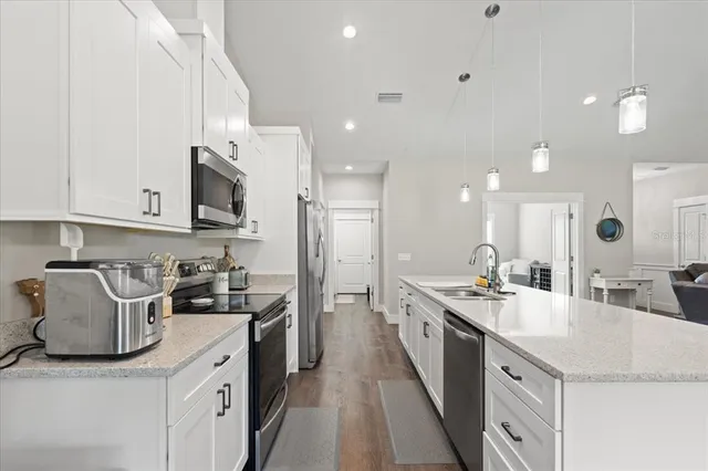 a kitchen with a sink stove and cabinets