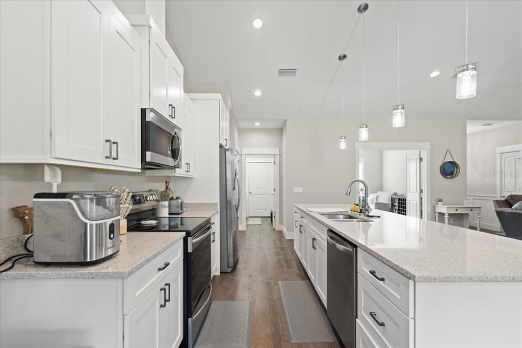335 Southwest Arrowbend Drive Lake City, FL 32024 - Photo 17 of 50 a kitchen with a sink stove and cabinets