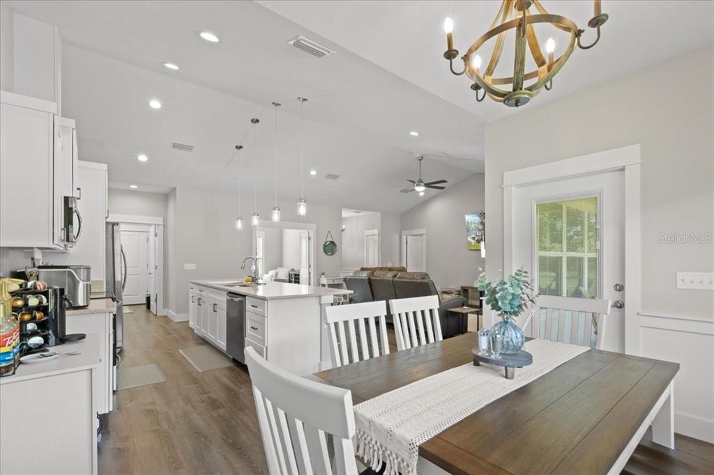 335 Southwest Arrowbend Drive Lake City, FL 32024 - Photo 20 of 50 a view of a dining room and livingroom with furniture wooden floor a chandelier