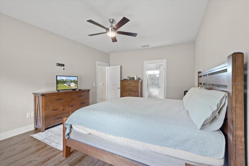 335 Southwest Arrowbend Drive Lake City, FL 32024 - Photo 24 of 50 a bedroom with a bed and a dresser