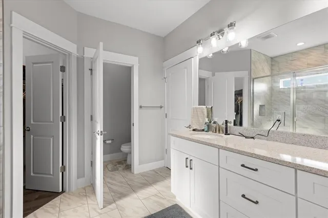 a bathroom with a double vanity sink and a mirror