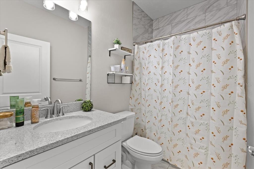 335 Southwest Arrowbend Drive Lake City, FL 32024 - Photo 28 of 50 a bathroom with a granite countertop sink a toilet and a mirror