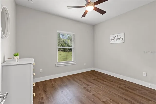 wooden floor in an empty room with a window