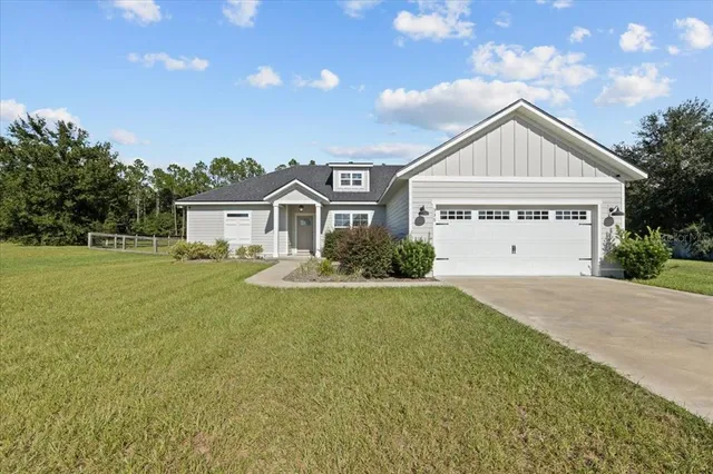 a view of house with yard and green space