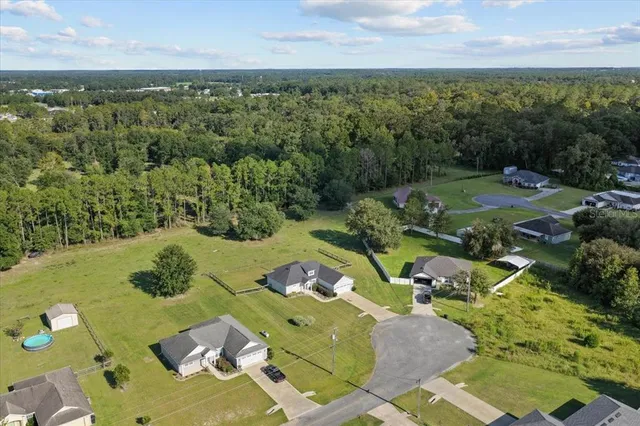 an aerial view of a house with garden space and outdoor seating