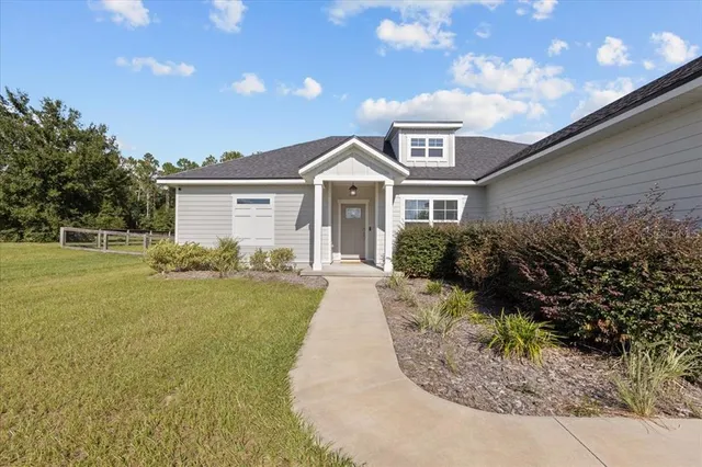 a front view of a house with garden