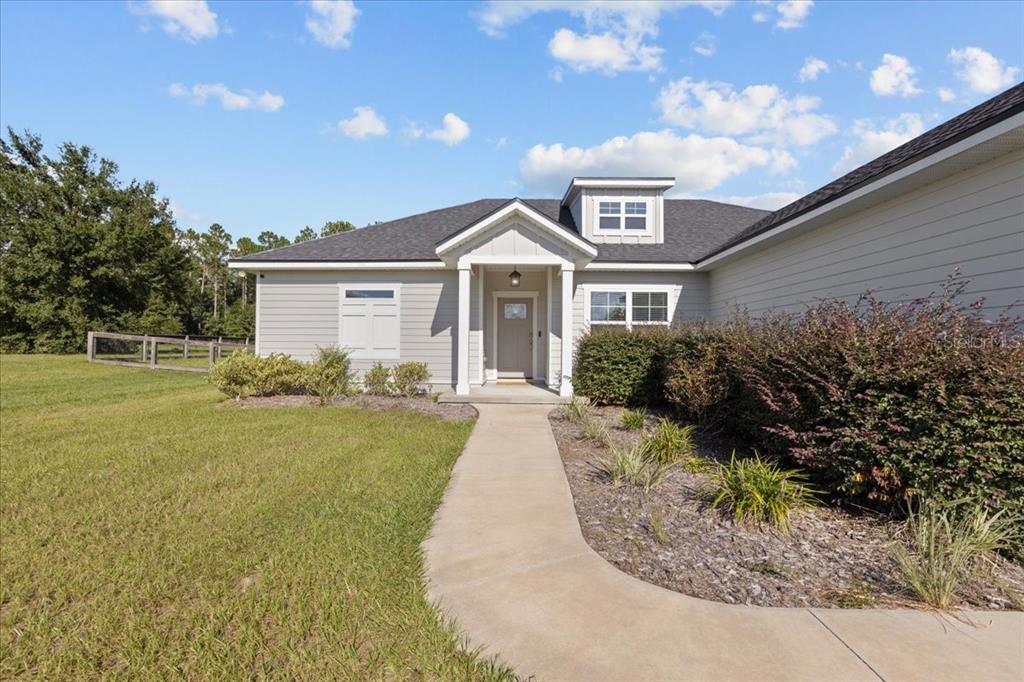 335 Southwest Arrowbend Drive Lake City, FL 32024 - Photo 4 of 50 a front view of a house with garden