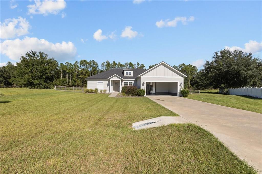 335 Southwest Arrowbend Drive Lake City, FL 32024 - Photo 44 of 50 a front view of a house with a yard and garage