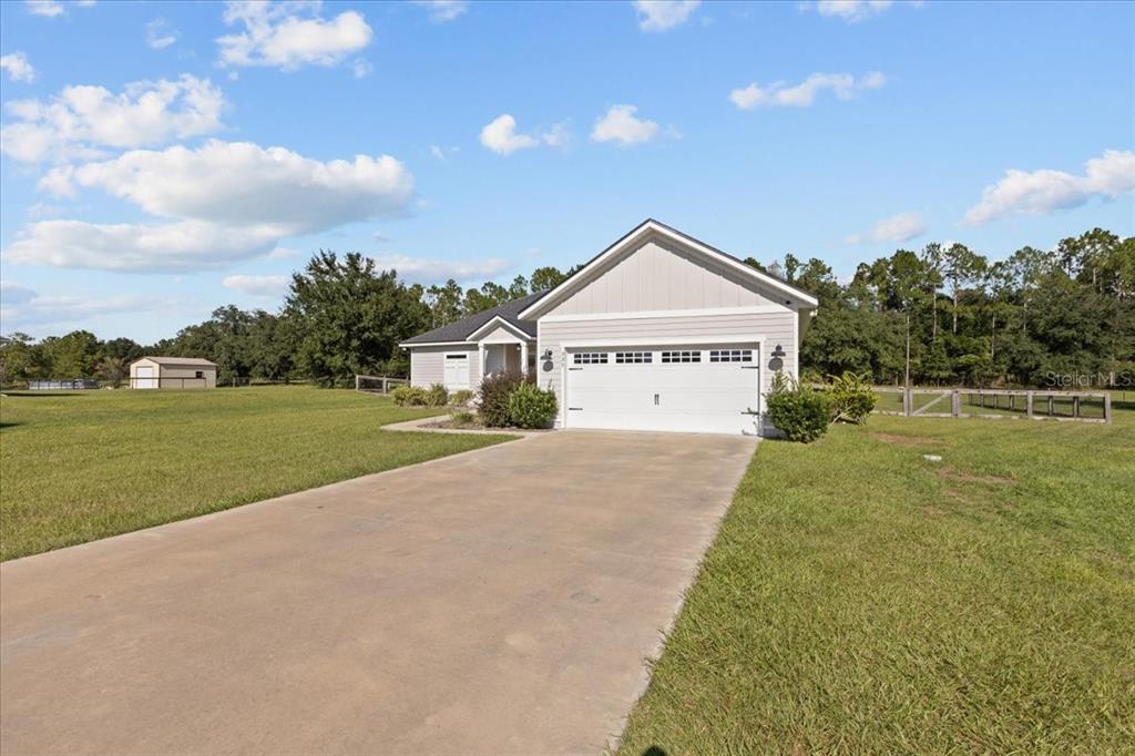 335 Southwest Arrowbend Drive Lake City, FL 32024 - Photo 45 of 50 a view of a house with a big yard next to a yard