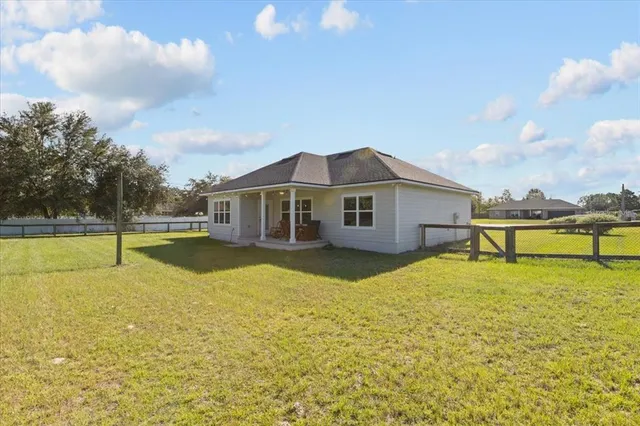 a house with swimming pool in front of it