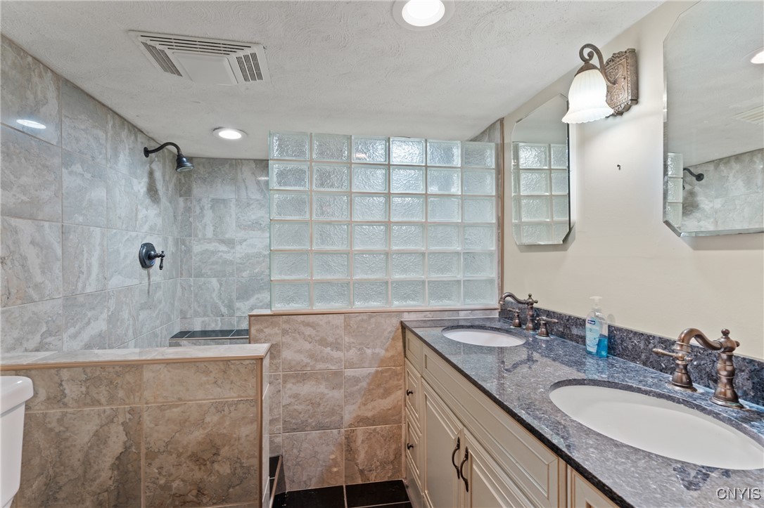 3860 South St Road Marcellus, NY 13108 - Photo 33 of 41 Full bathroom with walk-in shower in basement bedr