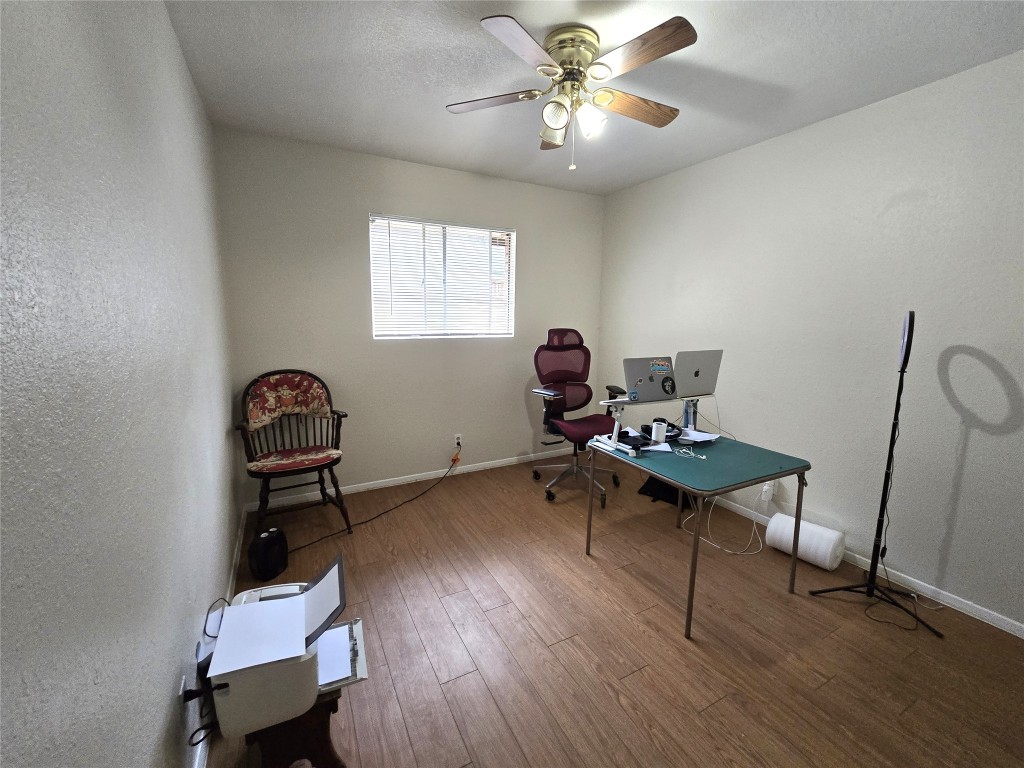 2600 Penny Lane, Unit 212 Austin, TX 78757 - Photo 14 of 35 a work room with furniture and wooden floor
